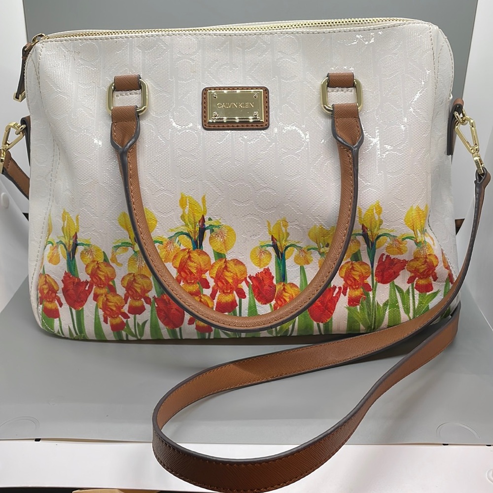 Calvin Klein “daffodil” bag. Zippered compartments and inside pockets.